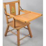 A Mid 20th Century Child's Feeding Chair with Hinged Tray