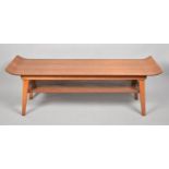 A 1970's "Surfboard" Coffee Table in Teak with Raised Ends and Stretcher Shelf, 112cm Long