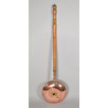 A 19th Century Circular Copper Bedwarming Pan with Turned Wooden Handle