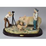 A Juliana Resin Figure Group Depicting Photographer Taking Prize Winning Pigs, 31cms Wide