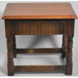 A Mid 20th Century Oak Rectangular Stool with Secret Drawer, 49 cms Wide