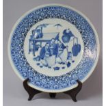 A 18th/19th Century Chinese Blue and White Charger Decorated with Seated Scholars Taking Tea, 37cm