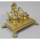 A French Brass Desktop Penrest and Two Bottle Inkstand on Four Claw Feet, 24cm Wide