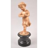 A Gilt Painted Spelter Study of a Young Girl Reading on Circular Socle, 22.5cm high