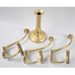 A Set of Three Brass Hat and Coat Hooks, Together with a Late 19th Century Brass Candlestick