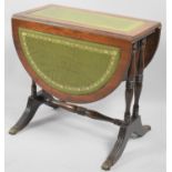 A Late 20th Century Drop Leaf Oval Topped Coffee Table on Turned Supports and Tooled Leather