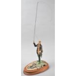 A Border Fine Arts Study of a Fly Fisherman, Model No.110 by David Geenty on Oval Wooden Base