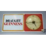 A Vintage Illuminated Shelf Mount Adverting Clock for Draught Guinness