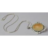 A Silver Floral Bordered Pendant with Oval Egg Yolk Stone on Silver Chain