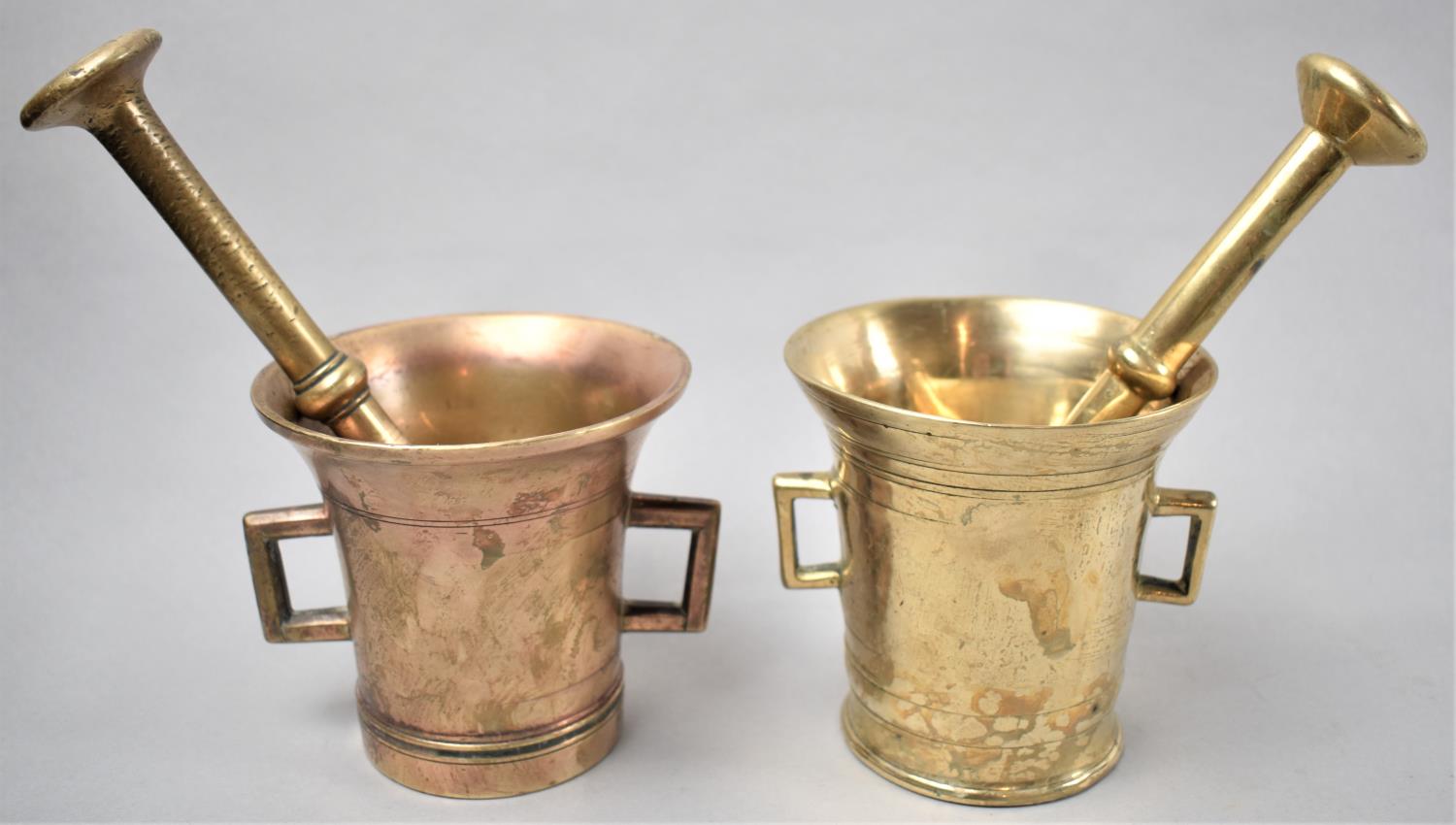 A Near Pair of Bronze and Brass Two Handled Mortars with Pestles, Each 10.5cm Diameter