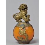 A Modern Oriental Ornament in the Form of Gilded Temple Dog Sat on Polished Stone Effect Globe,