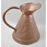 A Large Copper Measuring Jug, 31cm high