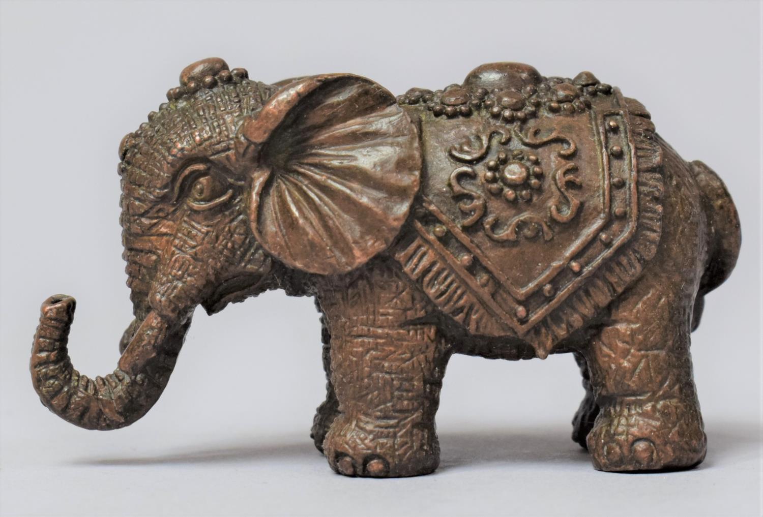 A Small Cast Bronze Study of an Indian Elephant with Trunk in Salute, 6cm Long