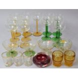 A Collection of Various Coloured Drinking Glasses to Include Seven Amber Stem Hocks, Five Green Stem