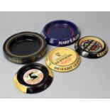 A Collection of Four Guinness and Harp Pressed Metal Advertising Ashtrays