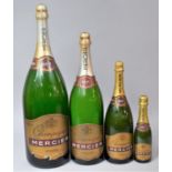 A Collection of Four Graduated Brut Display Bottles, Tallest Measuring 51cm High (All Empty)