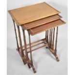 An Edwardian Mahogany and Satinwood Nest of Tables on Slender Turned Supports, the Largest 46cms
