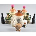 A Collection of Various Wade, Beswick and Other Stoneware Decanter Bottles