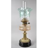 A Late Victorian Brass Based Oil Lamp with Glass Reservoir and Green Glass Wavy Rimmed Shade,