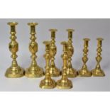 A Collection of Four Pairs of Victorian Brass Candlesticks, The Largest Inscribed The King Of