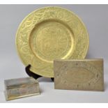 A Brass Circular Wall Plaque and Two Far Eastern Metal Cigarette Boxes