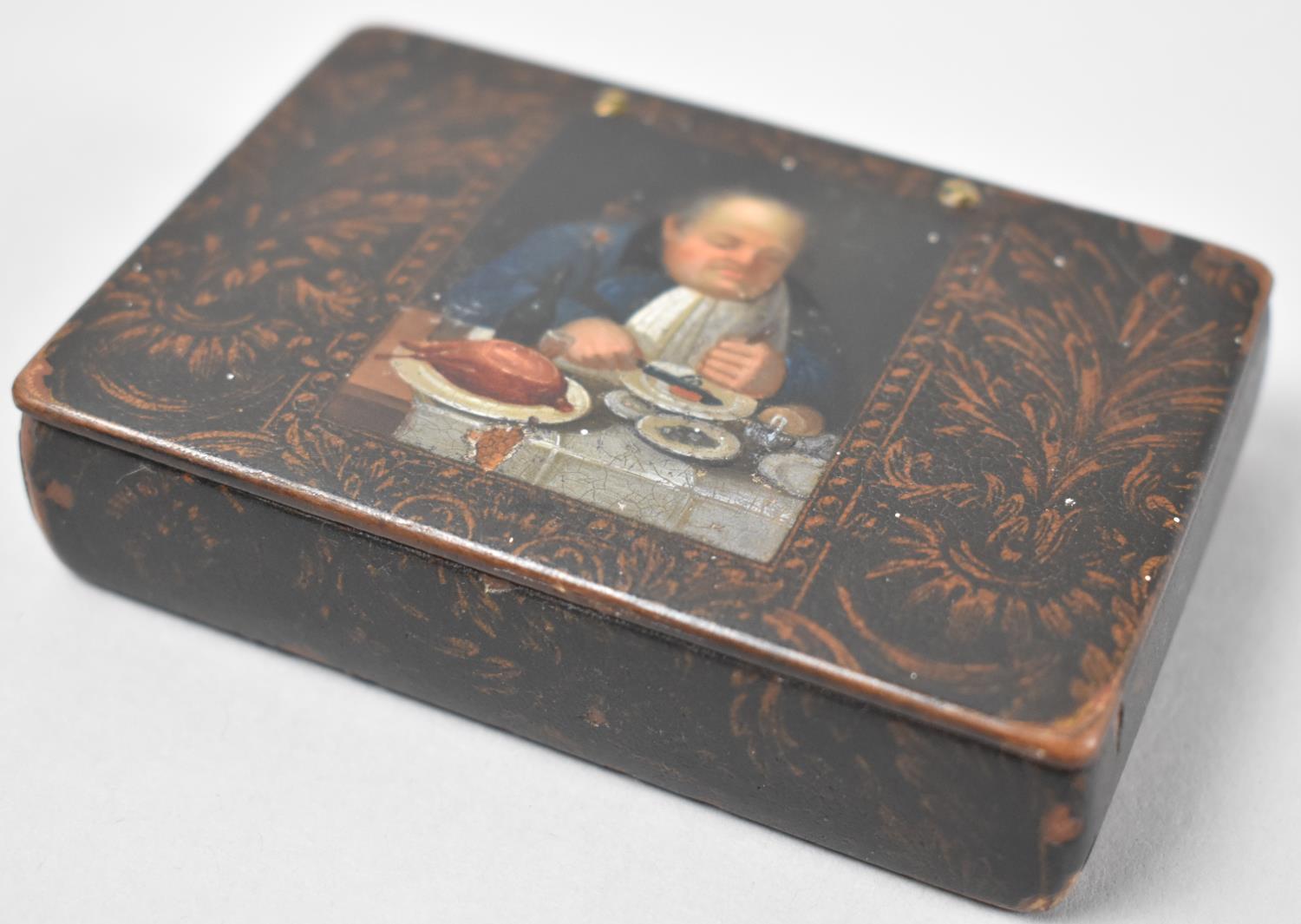 A 19th Century Lacquered Rectangular Snuff Box, the Hinged Lid Decorated with Gent Taking Supper,