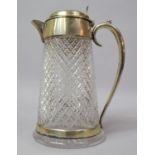 A Cut Glass Water Jug with Silver Plate Handle Lid and Pourer, 24cm high