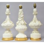 A Collection of Three Glazed Creamware Table Lamp Bases with Flower Decoration in Relief, Gilded