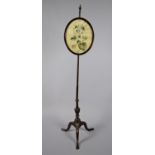 A 19th Century Mahogany Rise and Fall Pole Screen on Tripod Support with Oval Silk Embroidered Panel