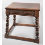 A Peg Jointed Rectangular Topped Oak Stool with Carved Decoration and Turned Bobbin Supports, 47cm