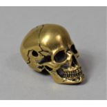 A Small Bronze Study of a Skull, 2.2cm high