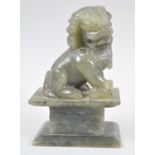 A Chinese Carved Jadeite Study of a Seated Temple Lion, 16cm high