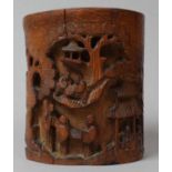 A Chinese Carved Brush Pot with Deeply Carved Decoration Depicting Elders and Pagodas, 14.5cm high