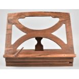 A Colonial Teak Music Stand with Folding Pierced Supports and Rest, 30.5cm wide