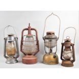 A Collection of Four Vintage Hurricane Lamps