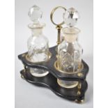 An Early 20th Century Bakelite and Brass Three Bottle Cruet