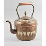 A North African Mixed Metal Kettle with Islamic Decoration, 31cm high