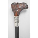 A Novelty Ebonised Walking Cane with White Metal Banding and Carved Wooden Handle in the Form of a