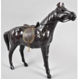 A Continental Leather Horse, with Saddle and Bridle, 32cm high