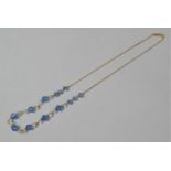 An Early 20th Century Blue and Clear Glass Faceted Bead Necklace on 9ct Gold Chain