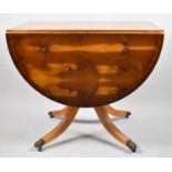 A Modern Yew Wood Drop Leaf Oval Dining Table with Claw Casters, 90cm Long