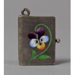 A Pretty Silver and Enamelled Miniature Charm in the Form of Book with Enamelled Pansy to Cover