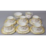 A Rose Patterned Yellow Bordered Tea Set to comprise Six Cups, Saucers and Side Plates, One Sugar