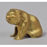 A Miniature Gilt Metal Study of a Seated Bear, 2cm high