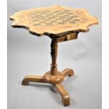 A Tripod Games Table Formed From a Section of Tree Trunk, Turned Support, 60cms High and with Two