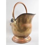 A Mid 20th Century Brass Helmet Shaped Coal Scuttle with Loop Handle, 35cms High