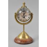 A Reproduction Gimballed Globular Ships Clock, the White Enamelled Dial with Anchor Design,