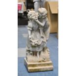 A Small Reconstituted Stone Garden Figural Ornament Depicting Boy and Girl Kissing, 41cms High