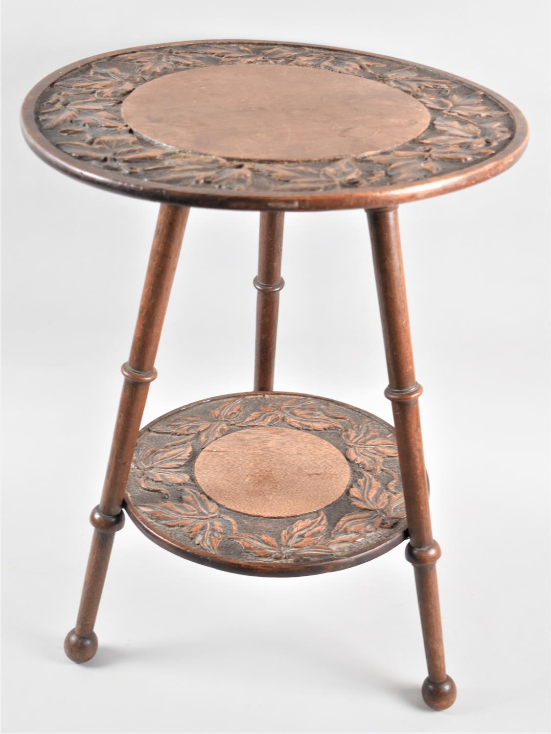 An Edwardian Circular Two Tier Tripod Table with Carved Bordered Top and Stretcher Shelf, 38.5cms