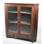 An Edwardian Oak Glazed Side Cabinet with Two Inner Shelves and Two Base Drawers, Canted Corners,